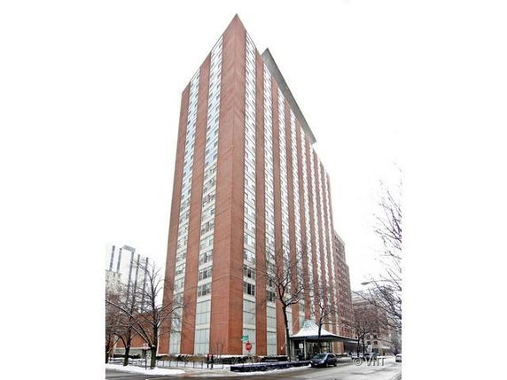 Front view of a tall multi-story residential building with a modern design.