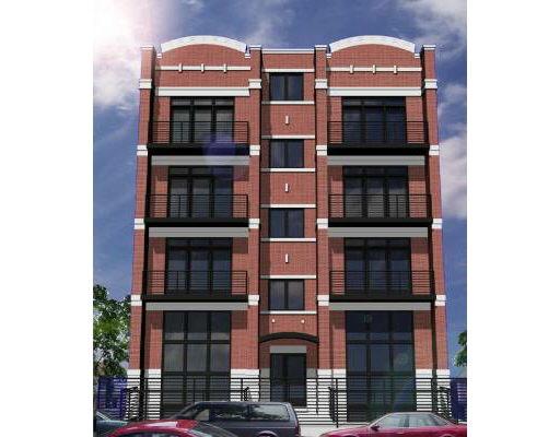 Front view of a multi-story brick building with large windows.
