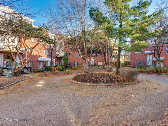 View of surrounding residential area with brick buildings and trees.