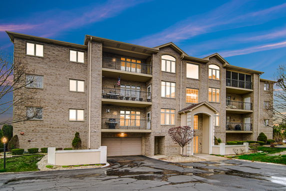 Front view of a multi-story apartment building with balconies.