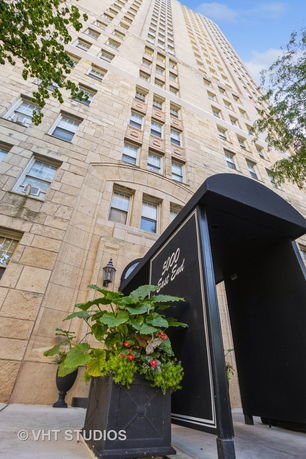 Front view of a tall stone building with multiple windows, featuring a black entrance canopy labeled '5000 East End'.