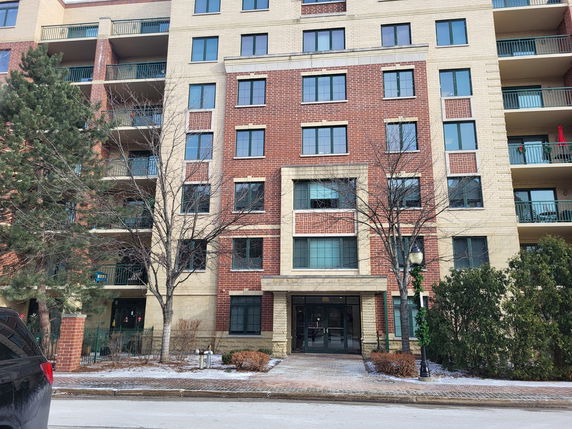 Front view of a multi-story building with brick and stone facade.