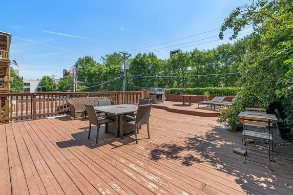 Rooftop area with patio furniture and a barbecue grill.