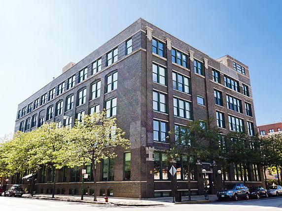 Front view of a multi-story brick building.