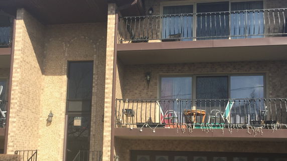 Front view of a multi-story building with balconies.