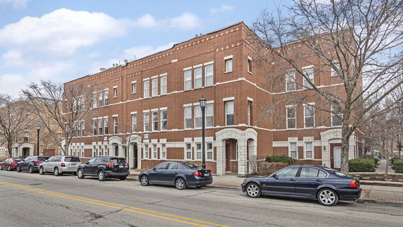 Front view of a three-story brick apartment building.