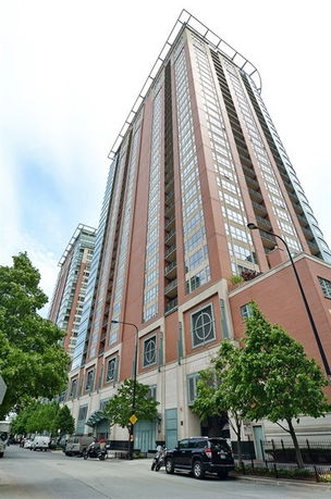 Front view of a tall multi-story residential building with a modern design.