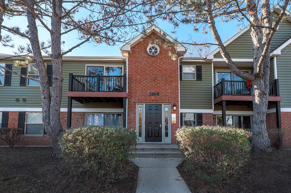 Front view of a two-story apartment building with brick and siding facade.