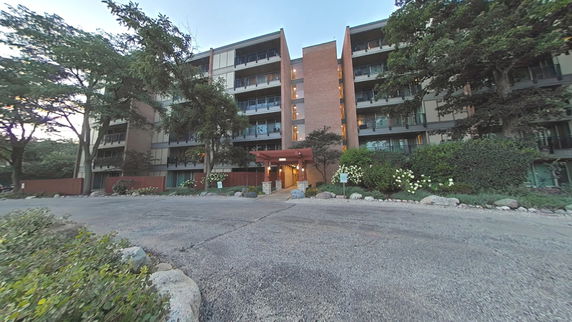 Front view of a multi-story building with balconies.