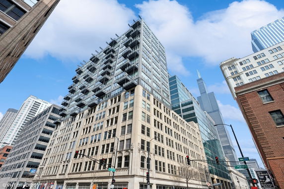 Front view of a multi-story building with a modern glass and concrete facade.