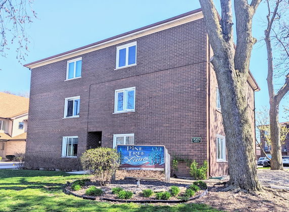 Front view of a three-story brick apartment building.