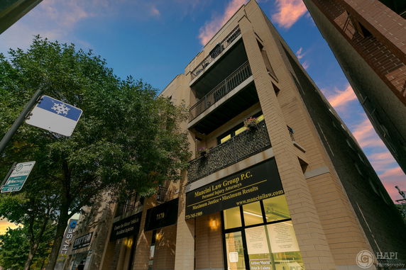 Front view of a multi-story building with a law office on the ground floor.