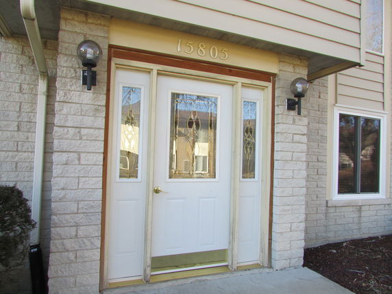Front view of a house with a decorative glass front door.