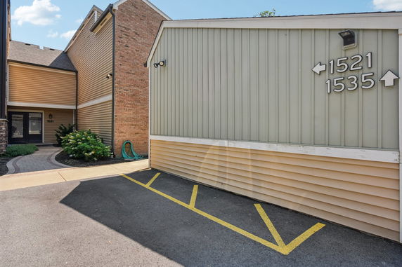 Front view of a multi-unit building with numbered entrances.