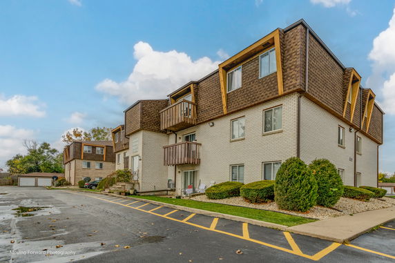 Front view of a multi-story residential building with balconies.