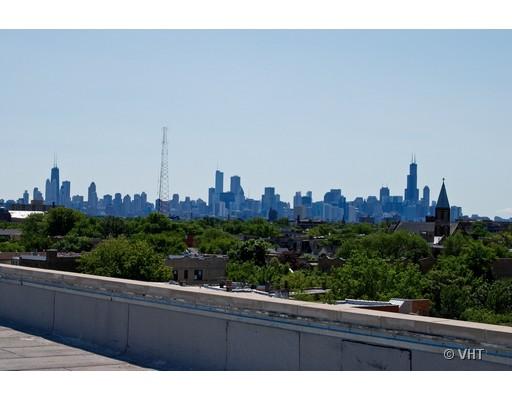 Panoramic view of a city skyline from a building rooftop.