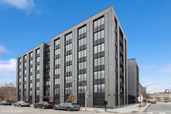 Front view of a multi-story building with large windows and a modern facade.