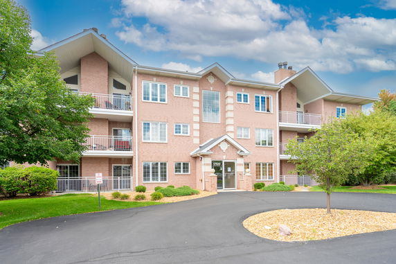 Front view of a multi-story residential building with balconies.
