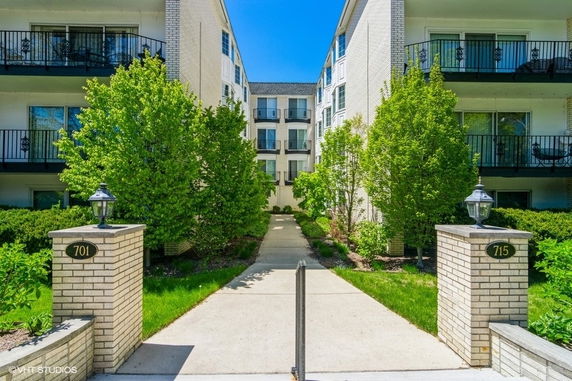 Front view of a multi-story apartment complex with balconies.