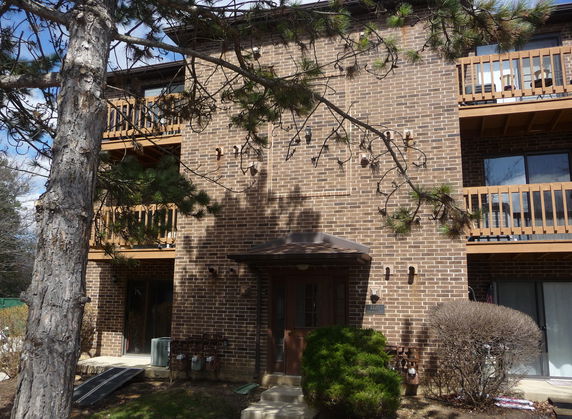 Front view of a multi-story brick building with balconies.
