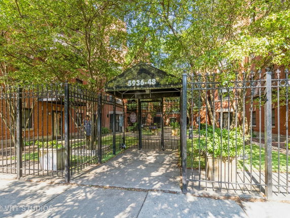 Front view of a building with a gated entrance.