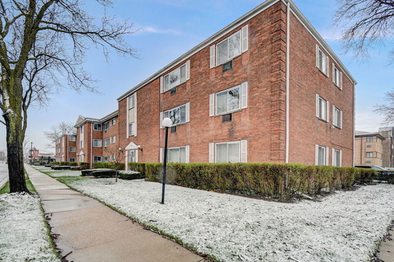 Front view of a three-story brick apartment building.