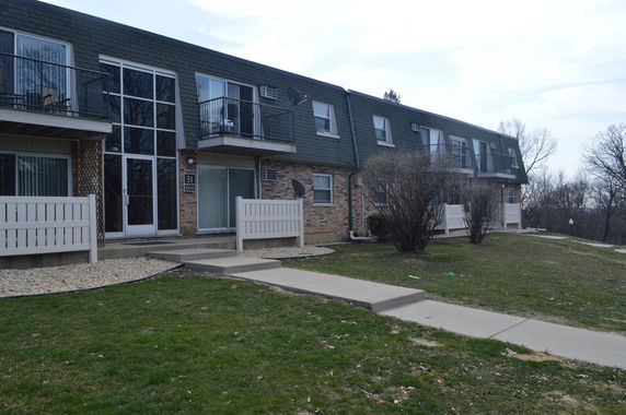 Front view of a two-story residential building with balconies.