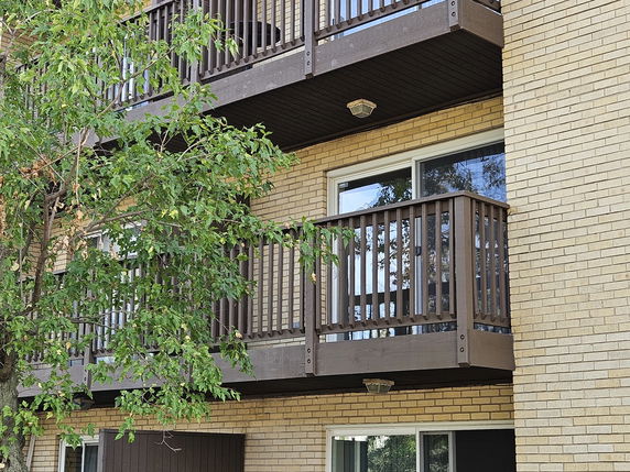 Front view of a multistory building with balconies.