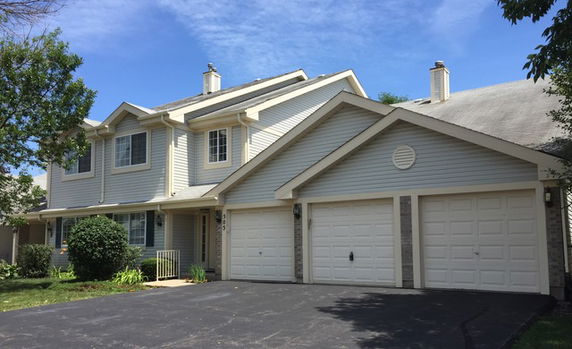 Front view of a two-story house with a double garage.