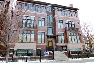 Front view of a multi-story brick apartment building.