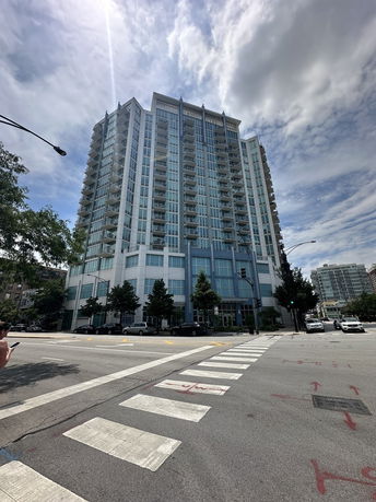 Front view of a multi-story residential building with balconies.