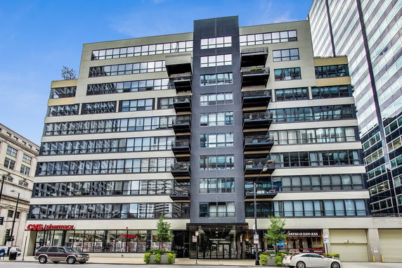 Front view of a multi-story commercial building with large windows and balconies.