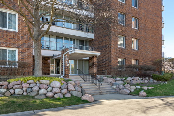 Front view of a multi-story brick building with balconies.