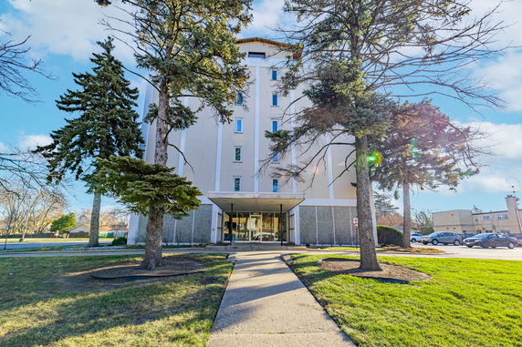 Front view of a multi-story building with a covered entrance.