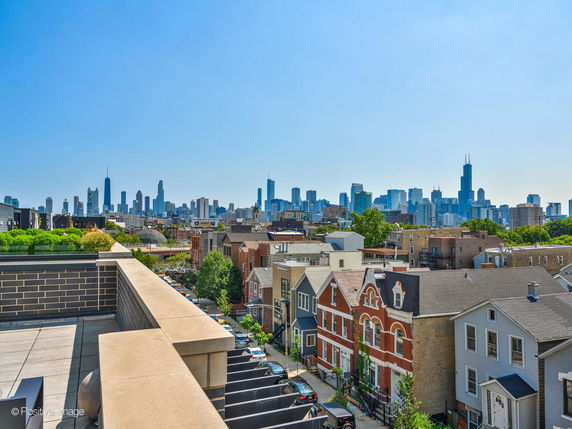 Panoramic view of city skyline with residential buildings in the foreground.
