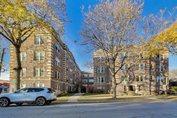 Front view of an apartment building with brick exterior and multiple stories.