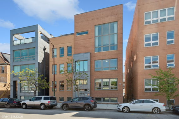 Front view of modern multi-story adjacent buildings with large windows.