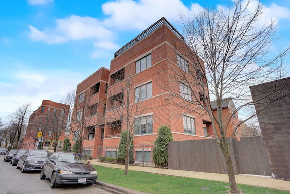 Front view of a multi-story brick apartment building.