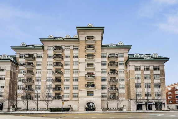Front view of a multi-story residential building with balconies.