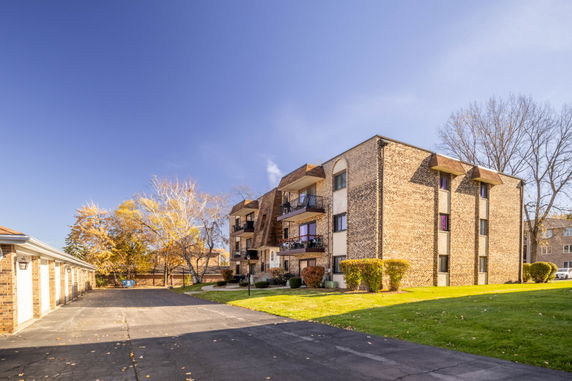 Front view of a multi-story brick apartment building.