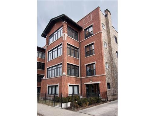 Front view of a multi-story brick apartment building.
