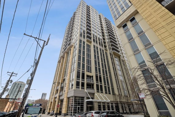 Front view of a high-rise building with multiple balconies.