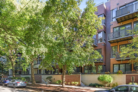 Front view of a multi-story residential building with balconies.
