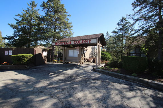 Front view of a building entrance with a sign reading 'Montego Colony'.