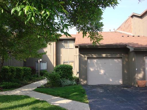 Front view of a two-story house with an attached garage.