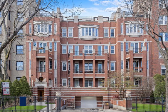 Front view of a multi-story brick apartment building.