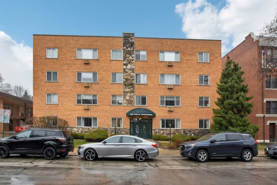 Front view of a multi-story brick condominium building.