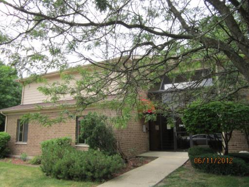 Front view of a two-story brick building with a glass entryway.