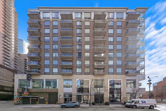 Front view of a multi-story apartment building with balconies.