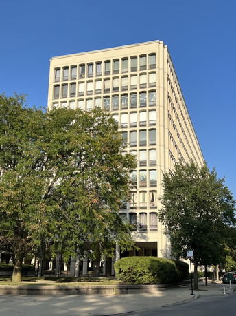 Front view of a multi-story building with a symmetrical design.